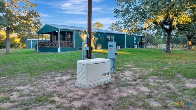 a front view of a house with a yard and tree