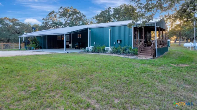 front view of a house with a yard and a garage