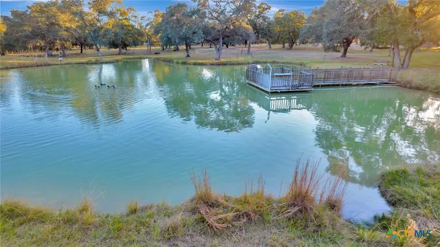 a view of a lake with a house in the background
