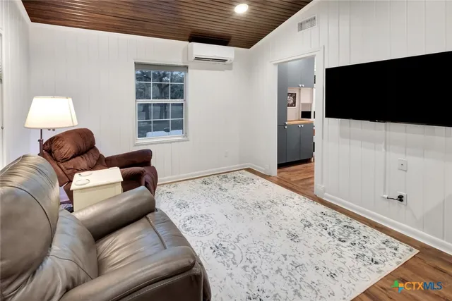a kitchen with granite countertop white cabinets and stainless steel appliances