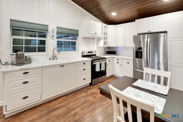 a kitchen with stainless steel appliances granite countertop a stove and a microwave