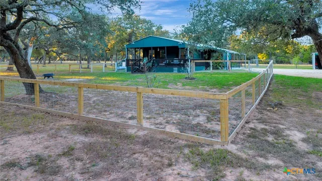 a view of a house with backyard porch and sitting area