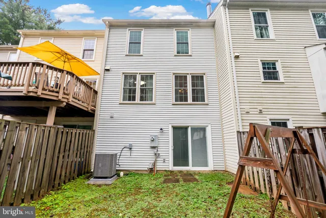 a view of a house with backyard and porch