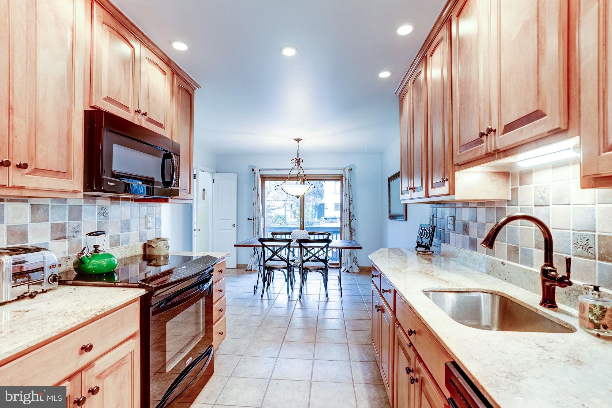 2035 Golf Course Drive Reston, VA 20191 - Photo 12 of 28 a kitchen with granite countertop a sink and appliances