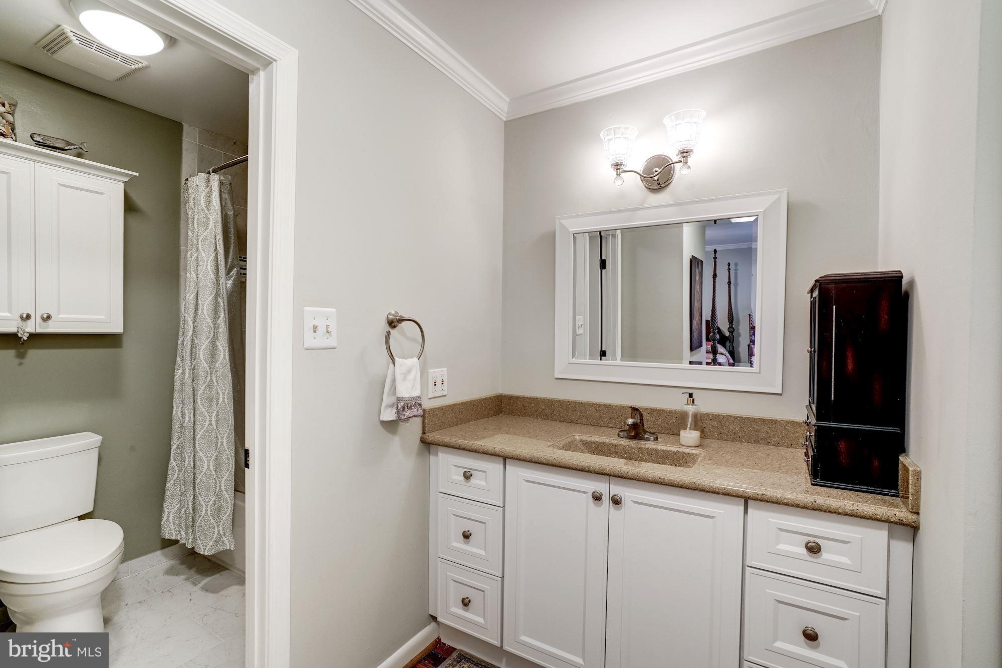 2035 Golf Course Drive Reston, VA 20191 - Photo 16 of 28 a bathroom with a granite countertop sink and a mirror