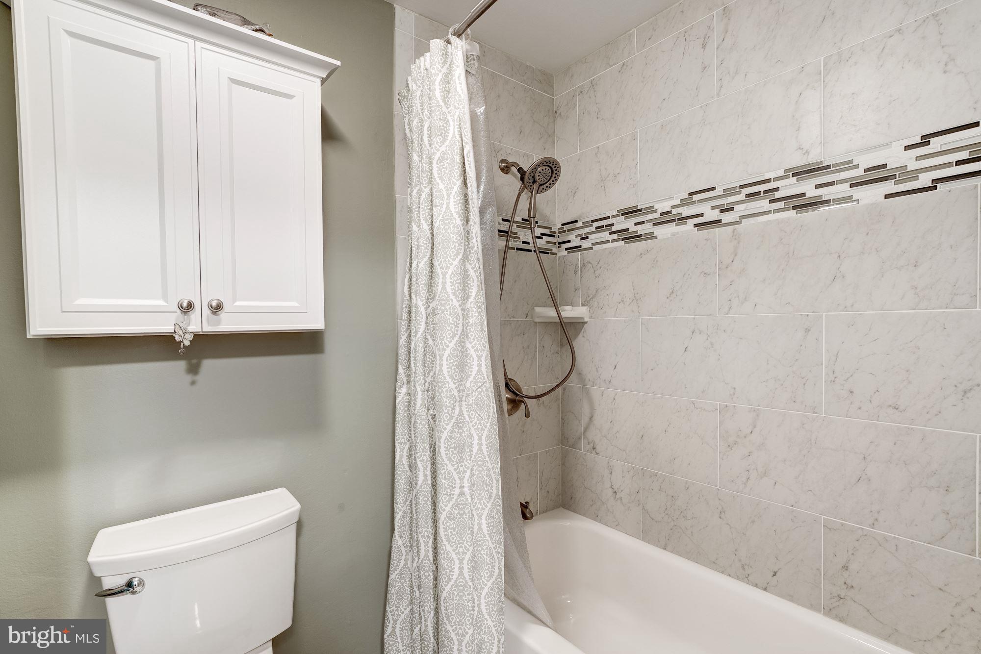 2035 Golf Course Drive Reston, VA 20191 - Photo 17 of 28 a bathroom with a shower a toilet and a sink