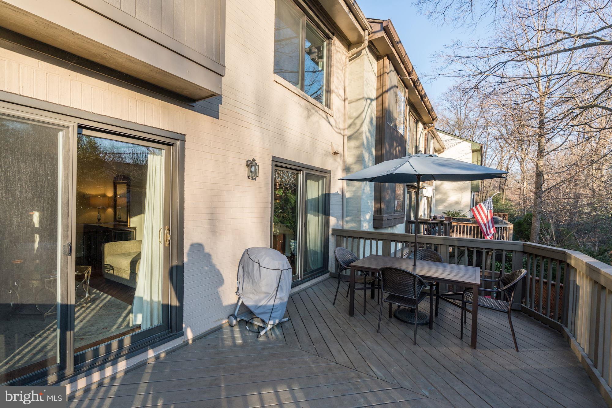 2035 Golf Course Drive Reston, VA 20191 - Photo 24 of 28 a view of a patio with table and chairs with wooden floor and fence