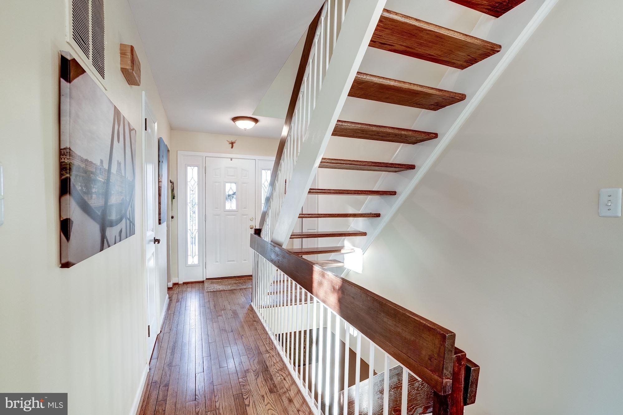 2035 Golf Course Drive Reston, VA 20191 - Photo 5 of 28 a view of staircase with wooden floor and white walls
