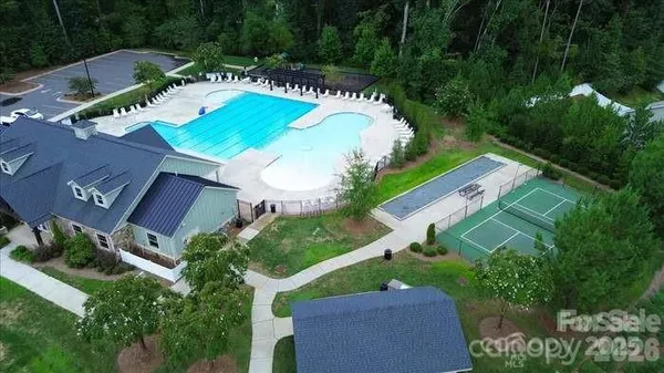 an aerial view of a house with a swimming pool yard and outdoor seating