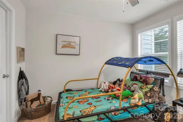 a bathroom with a granite countertop sink a toilet and a large mirror
