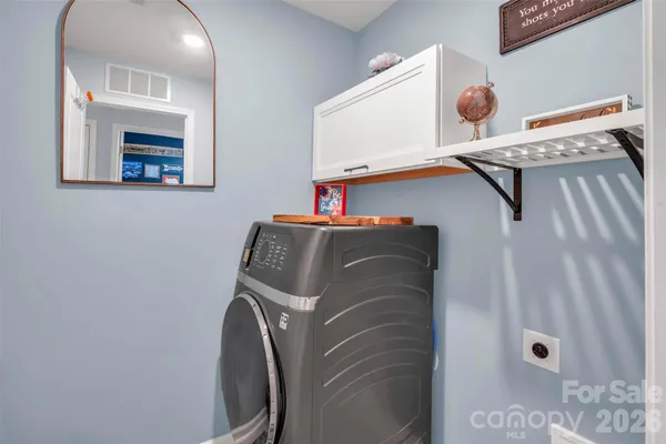 a view of walk in closet with clothes