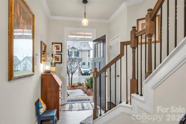 a kitchen with stainless steel appliances granite countertop a sink a stove a microwave a refrigerator and white cabinets