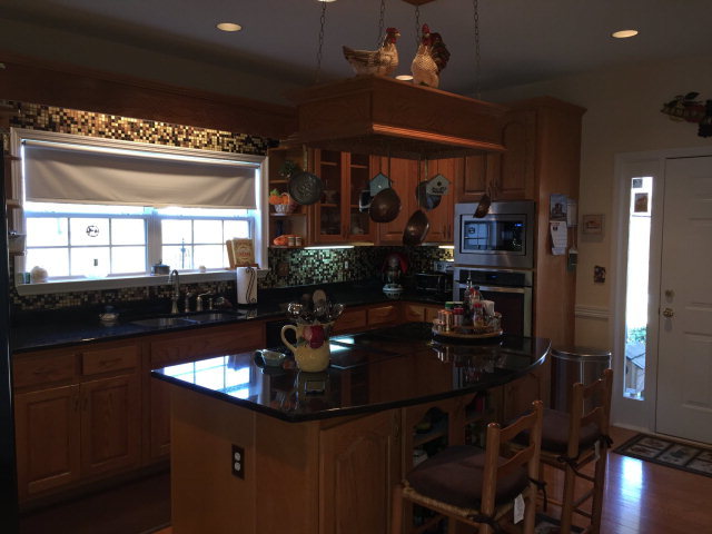 4433 Johnstonville Road Forsyth, GA 31029 - Photo 12 of 37 a kitchen with a table chairs and flat screen tv