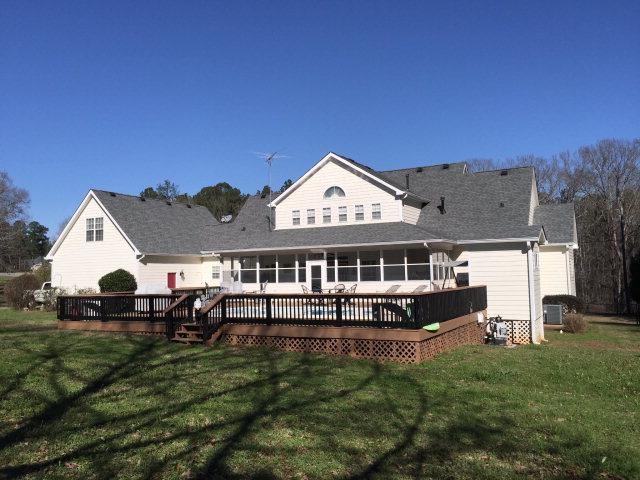 4433 Johnstonville Road Forsyth, GA 31029 - Photo 20 of 37 a front view of a house with a garden and lake view