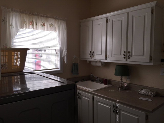 4433 Johnstonville Road Forsyth, GA 31029 - Photo 28 of 37 a kitchen with a sink a window and cabinets