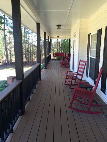 4433 Johnstonville Road Forsyth, GA 31029 - Photo 30 of 37 a view of balcony with chairs and wooden floor