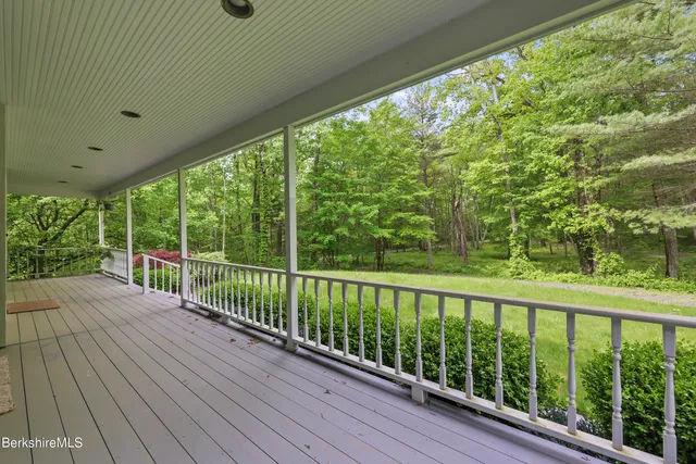 a view of a backyard with a small deck and a garden