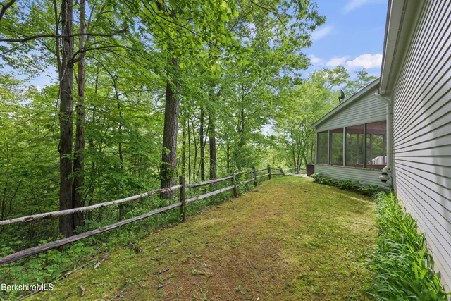 a view of a house with a yard and sitting area
