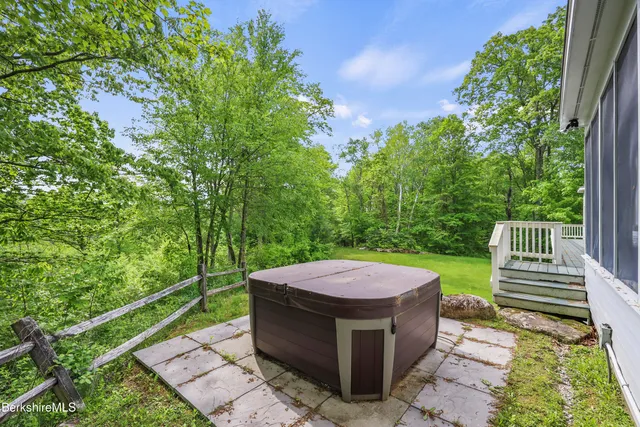 a view of a house with a big yard and large trees