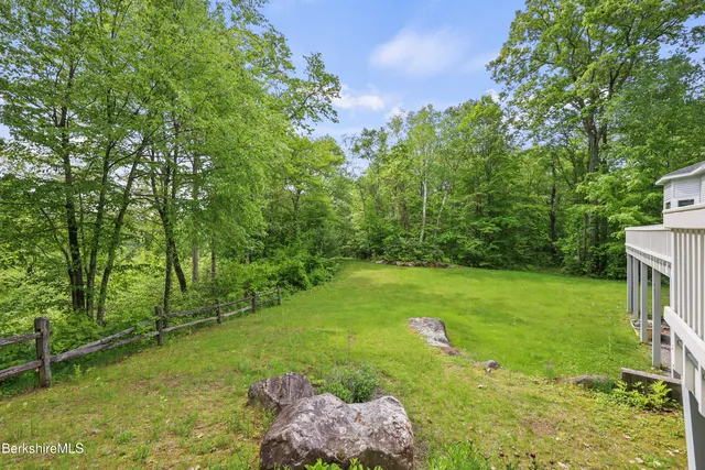 a aerial view of a house with a yard and sitting area