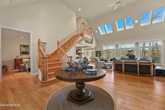 a living room with fireplace furniture and a wooden floor