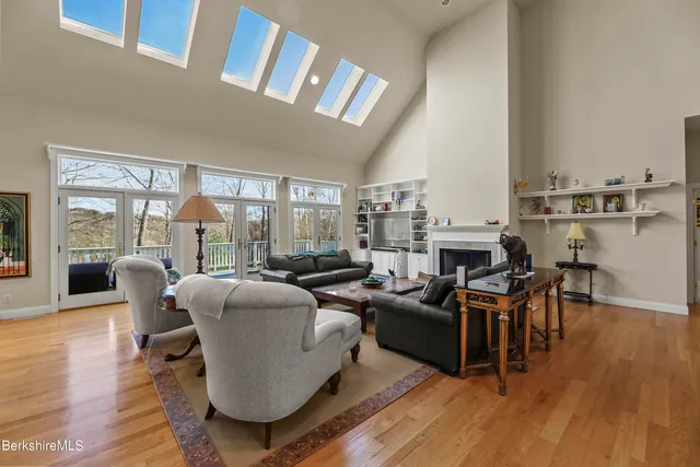 a living room with furniture kitchen view and a large window