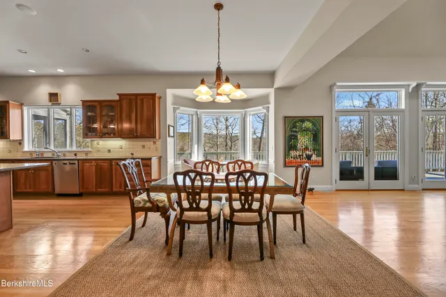 a kitchen with stainless steel appliances granite countertop wooden floors and sink