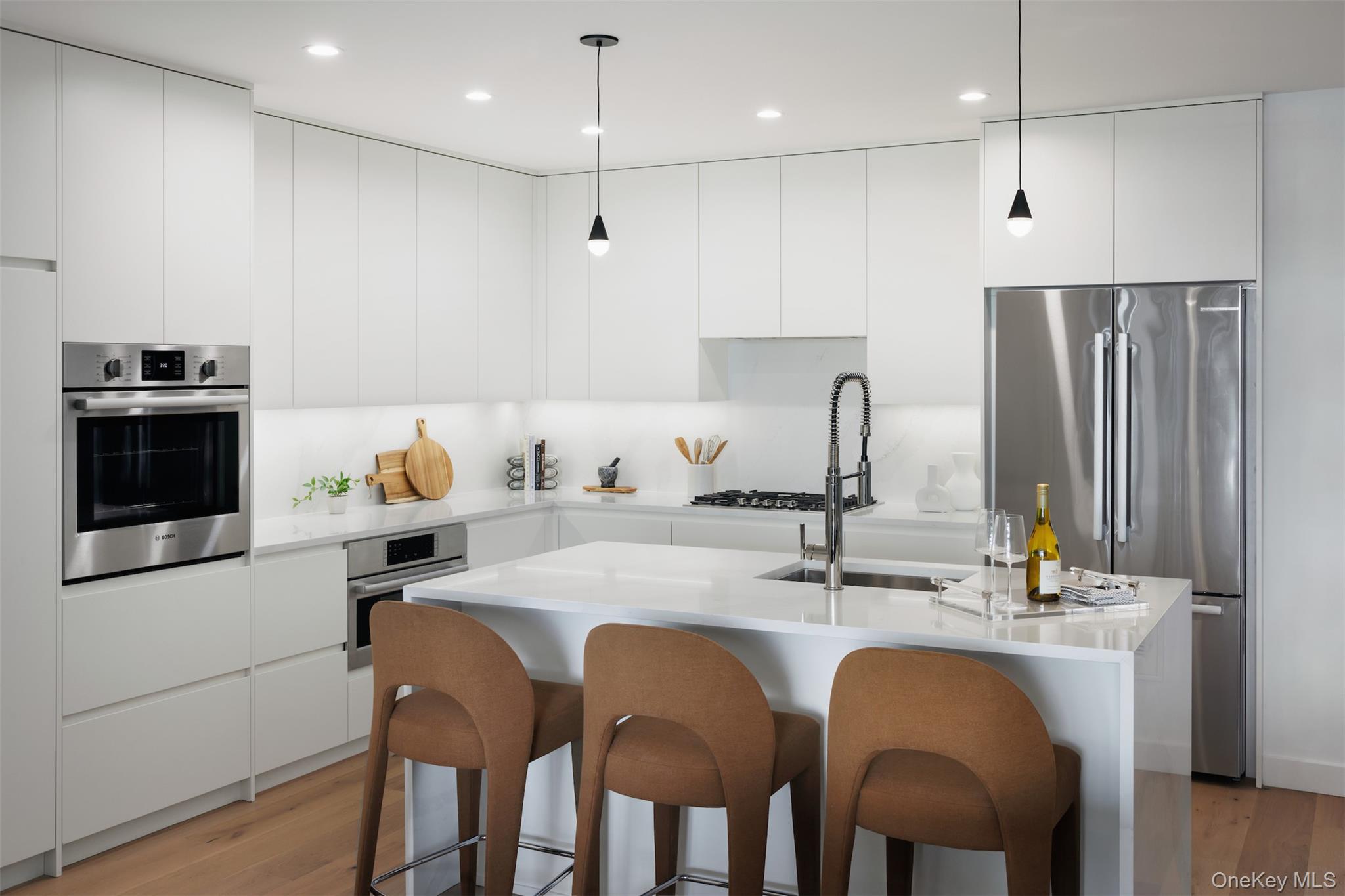 140 Boardwalk, Unit L3 B Long Beach, NY 11561 - Photo 1 of 31 a kitchen with stainless steel appliances granite countertop a sink a stove a refrigerator and island with wooden floor