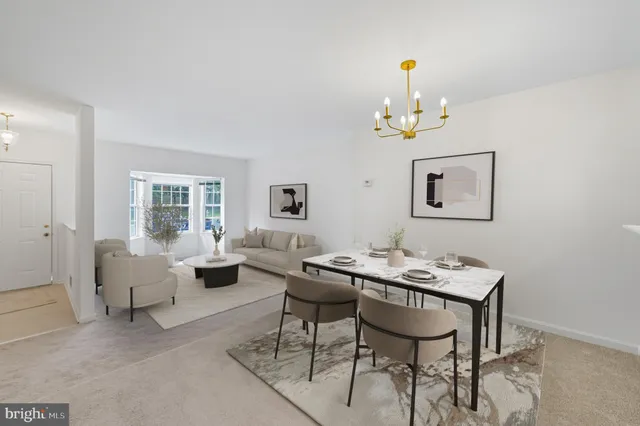 a dining room with wooden floor a chandelier fan a wooden table and chairs