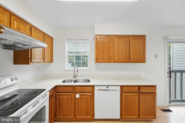 a kitchen with granite countertop cabinets sink and window