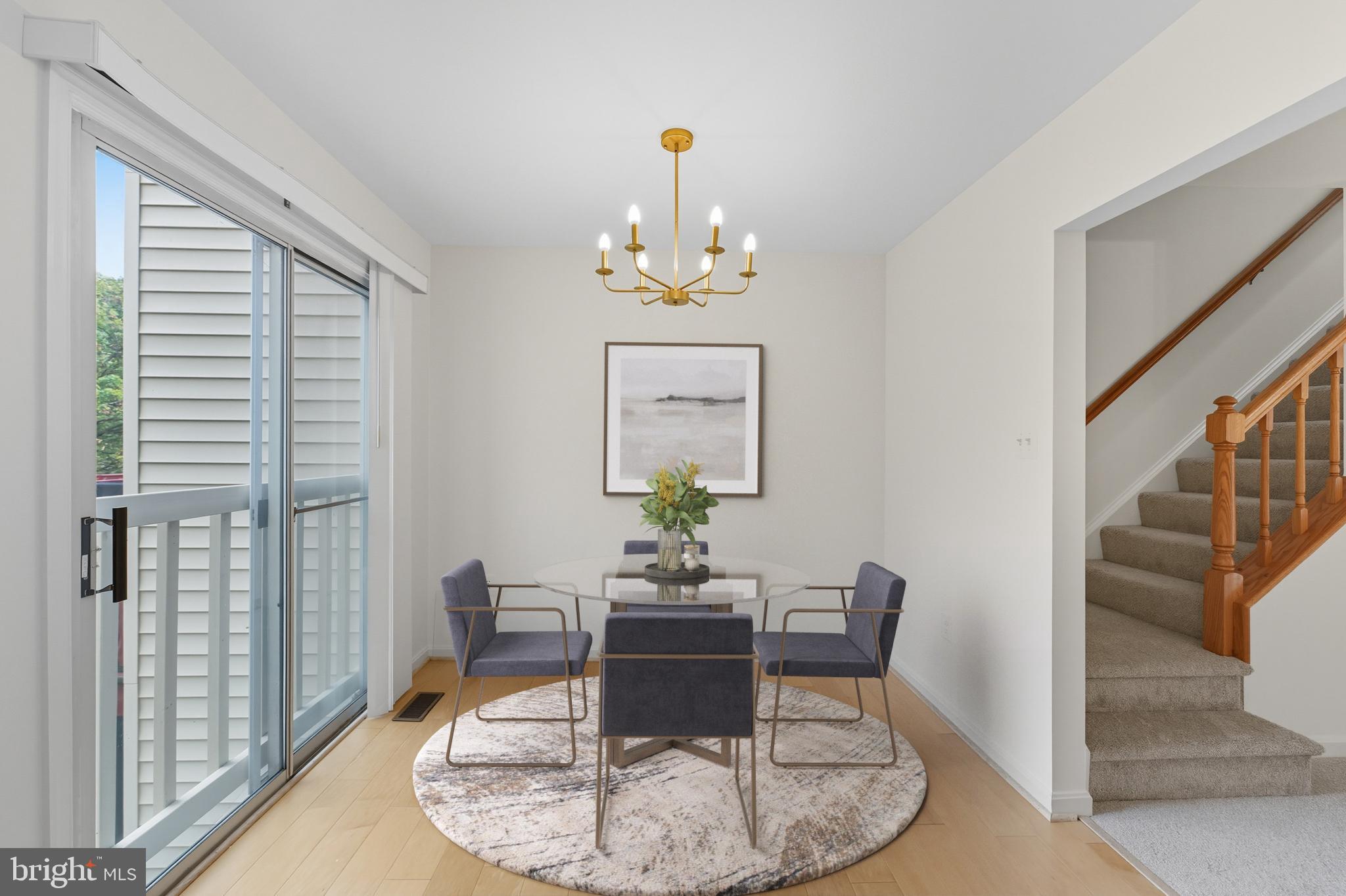 2724 Hunters Gate Terrace Silver Spring, MD 20904 - Photo 21 of 46 a dining room with wooden floor a chandelier a wooden table and chairs