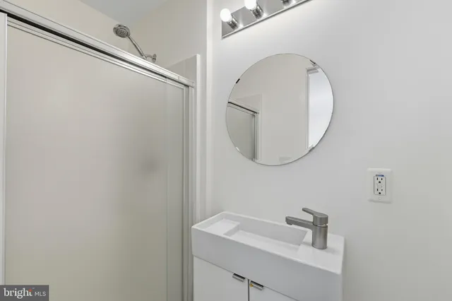 a bathroom with a sink and mirror