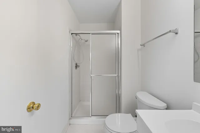 a white toilet sitting next to a bathroom sink