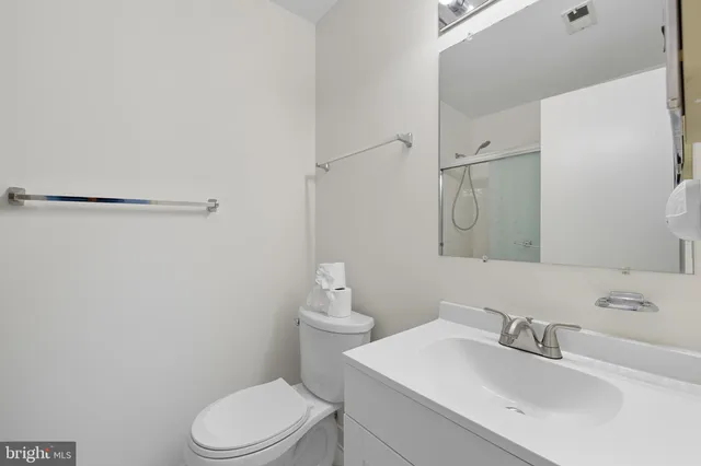 a bathroom with a sink toilet and a mirror