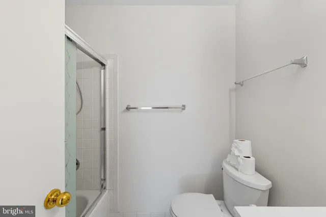 a white toilet sitting next to a bathroom sink