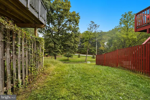 a view of yard with swimming pool and trees