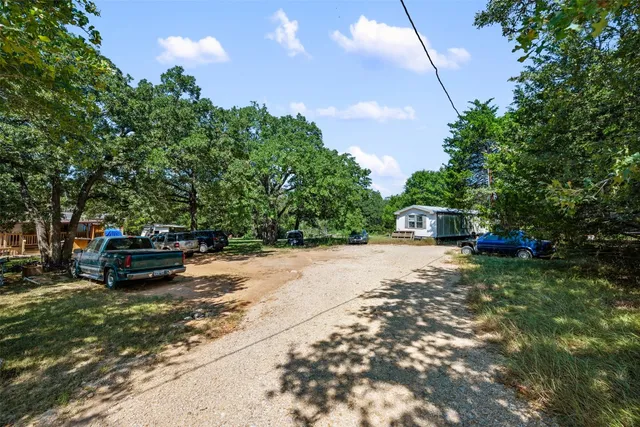 a view of a house with truck parked in a yard