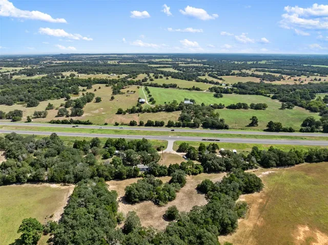 an aerial view of a house with a yard and outdoor seating