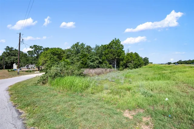 a view of a yard with a house in the background