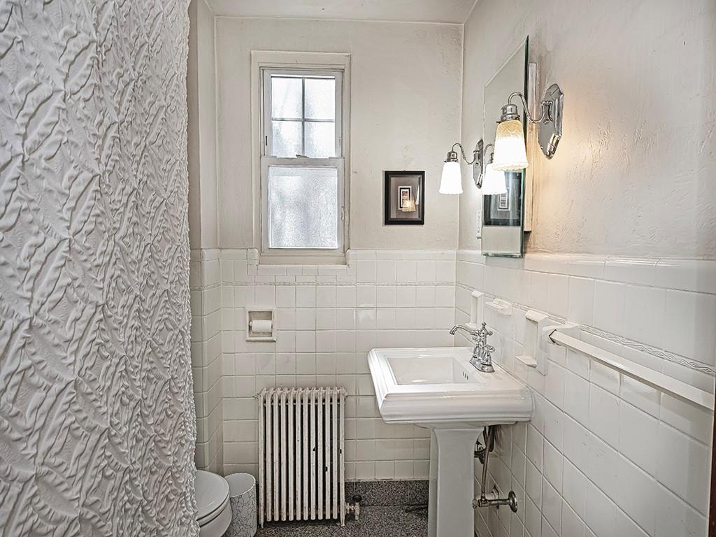 902 Delafield Road Pittsburgh, PA 15215 - Photo 11 of 23 a bathroom with a sink a mirror and a toilet