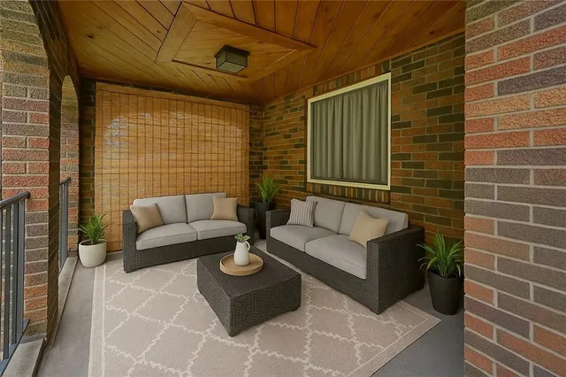 a view of a patio with couches and a potted plant on a table
