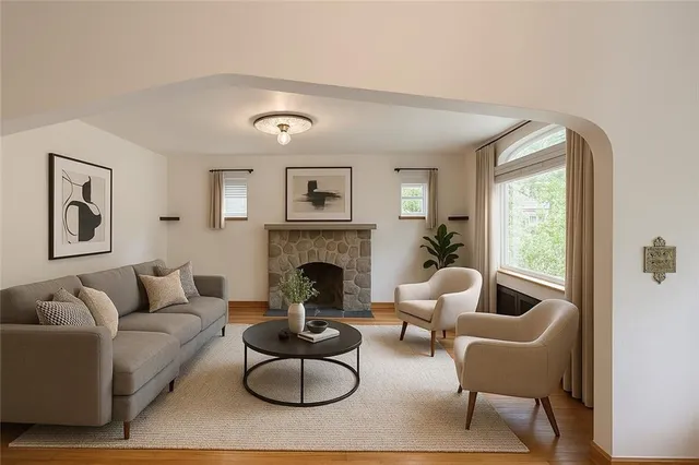 a living room with furniture and a fireplace