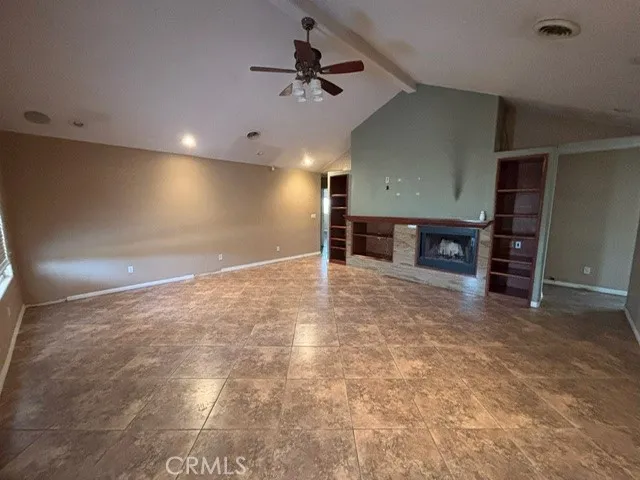 an empty room with furniture and a fireplace