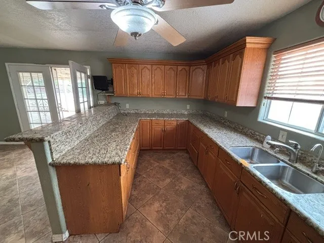 a kitchen with stainless steel appliances granite countertop a sink and a counter space