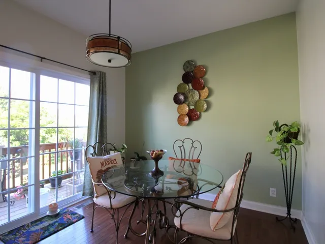 a view of a dining room with furniture wooden floor and a chandelier