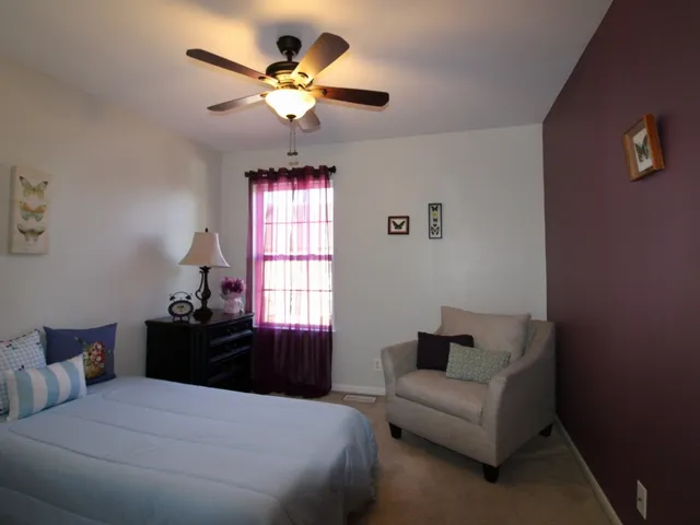 a bedroom with a bed and a couch