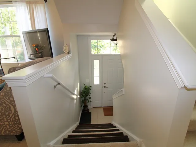 a view of a livingroom with furniture and staircase