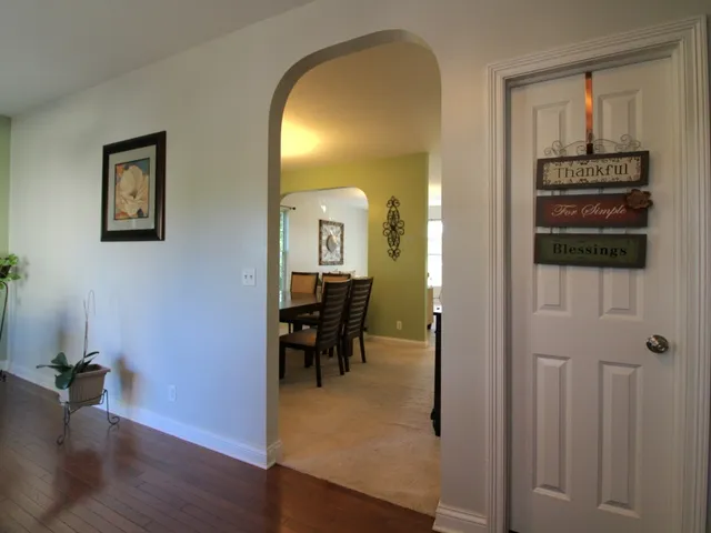 a view of a livingroom with furniture and a hallway