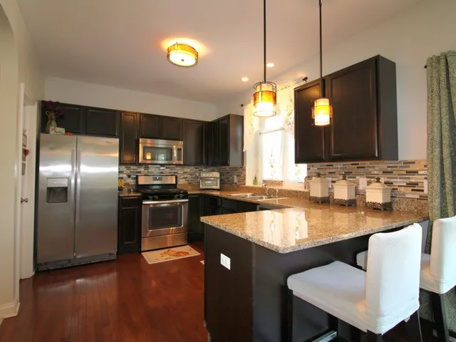 a kitchen with a center island and stainless steel appliances