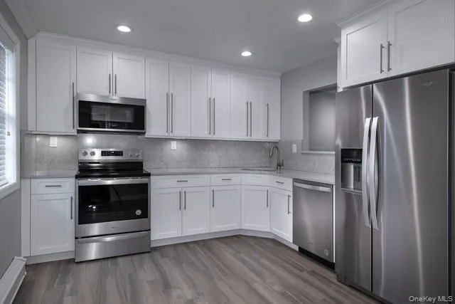 a kitchen with a refrigerator and a stove top oven